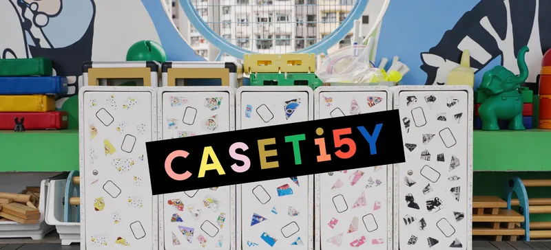 Row of white upcycled cabinets in a preschool classroom, with the CASETiFY logo