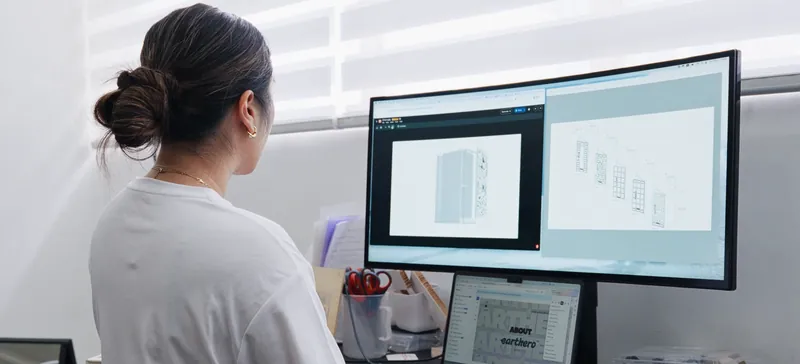 Designer reviewing a cabinet drawing on a large monitor