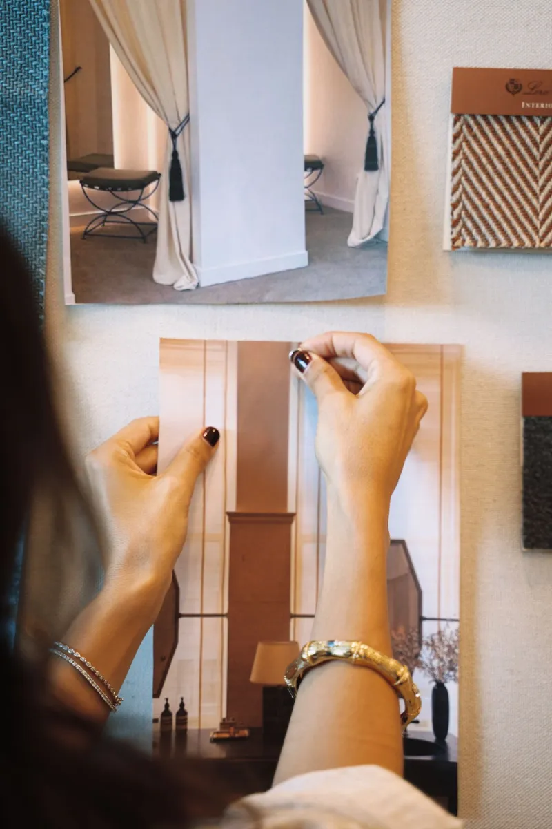 Hand pinning an image to a mood board