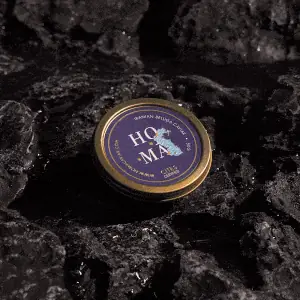 Homa caviar tin on dark volcanic rock
