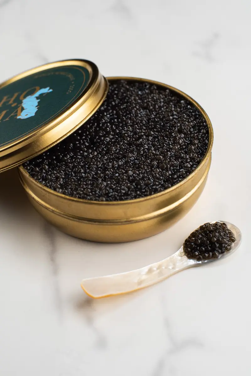 Caviar tin with a mother-of-pearl spoon on marble