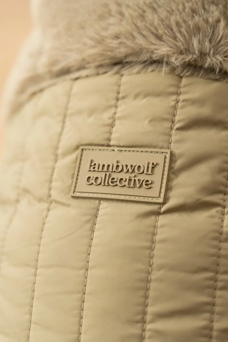 Close-up of a quilted Lambwolf Collective dog bed label