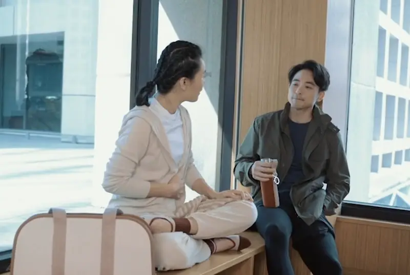 Two people talking in a bright, modern living room