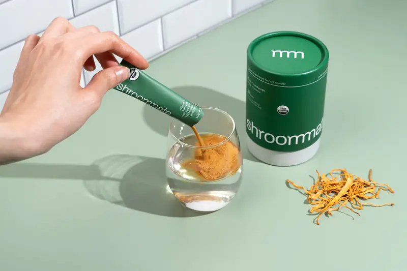 Spoonful of Shroommate powder over a glass