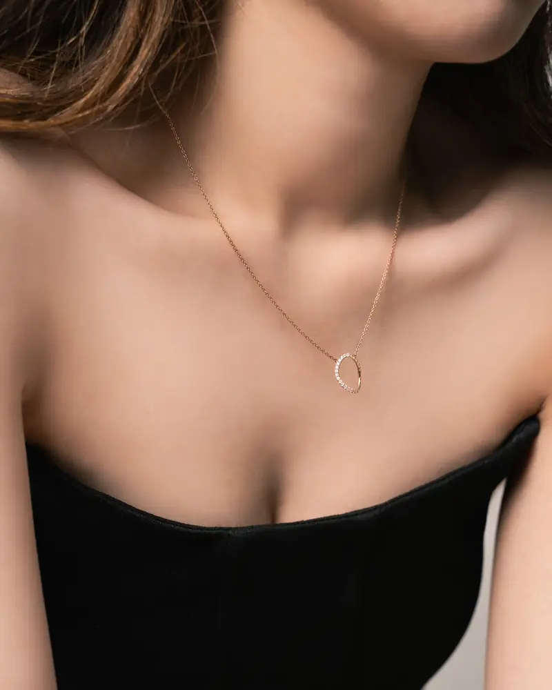 Model wearing a fine necklace with a black top
