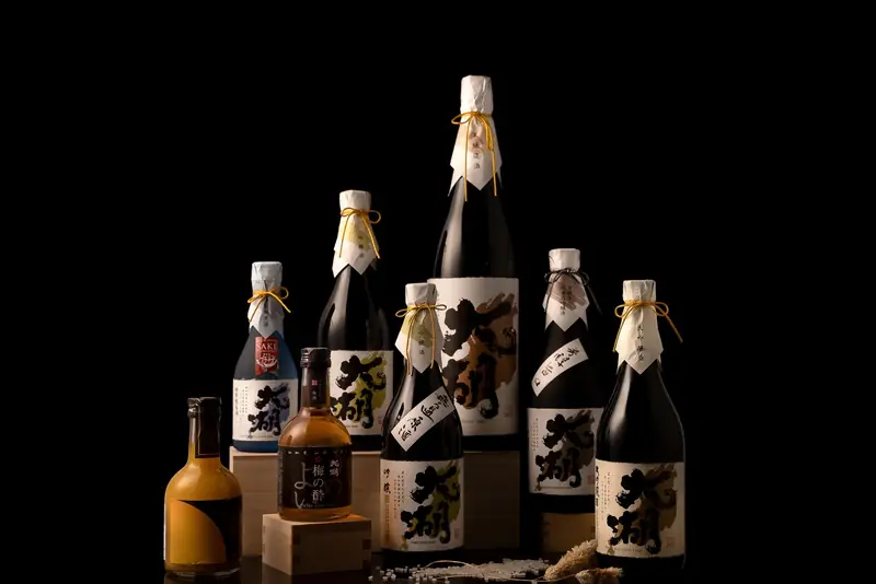 Bottles of Japanese sake arranged on a black background