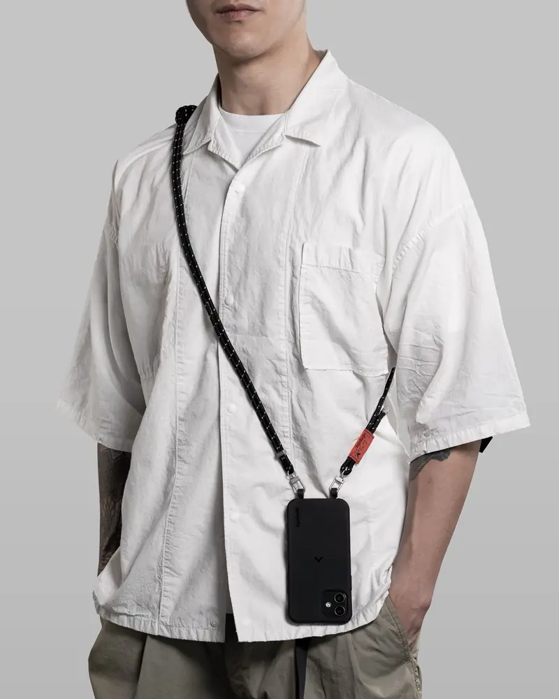 Model in a white shirt wearing a phone sling