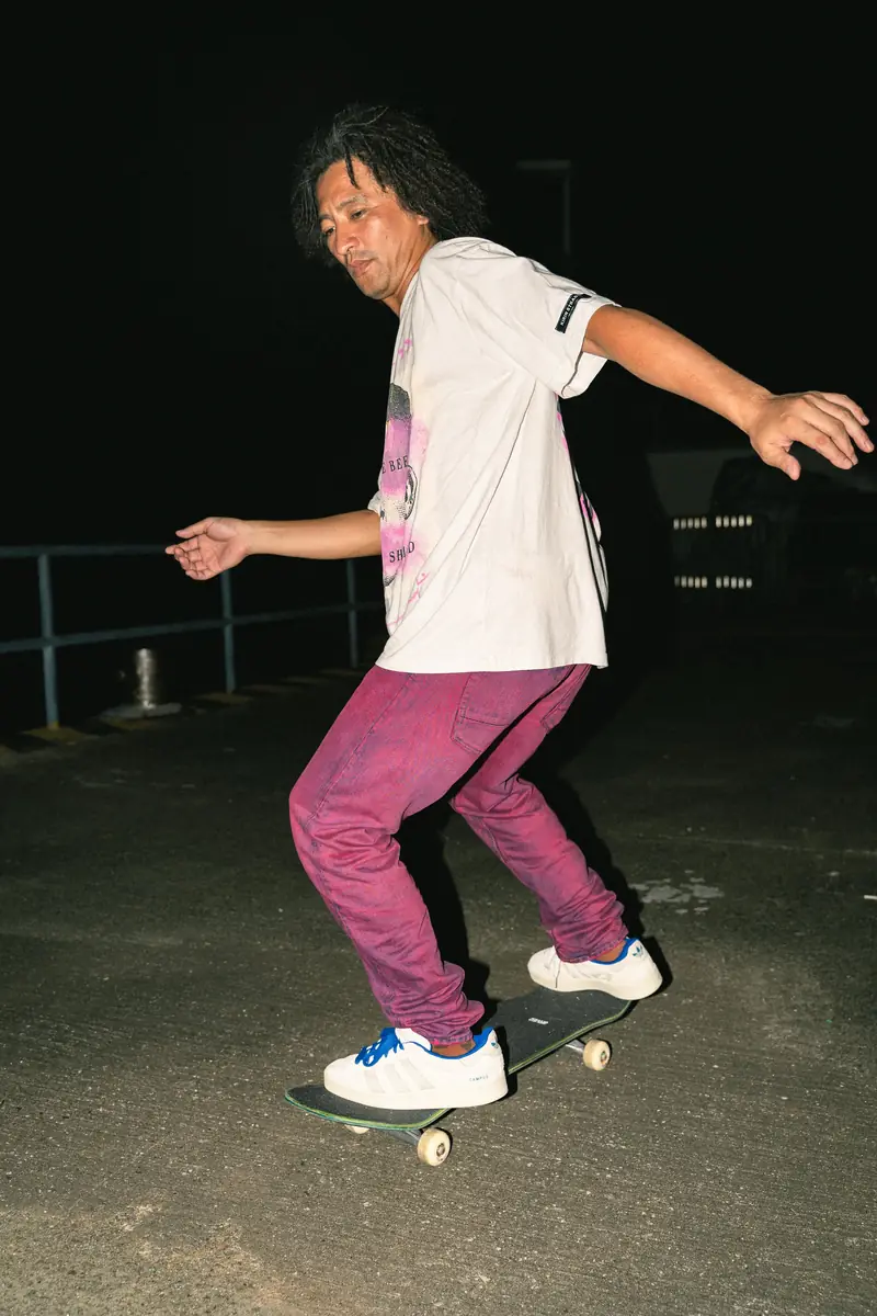 Model dancing in jeans at night