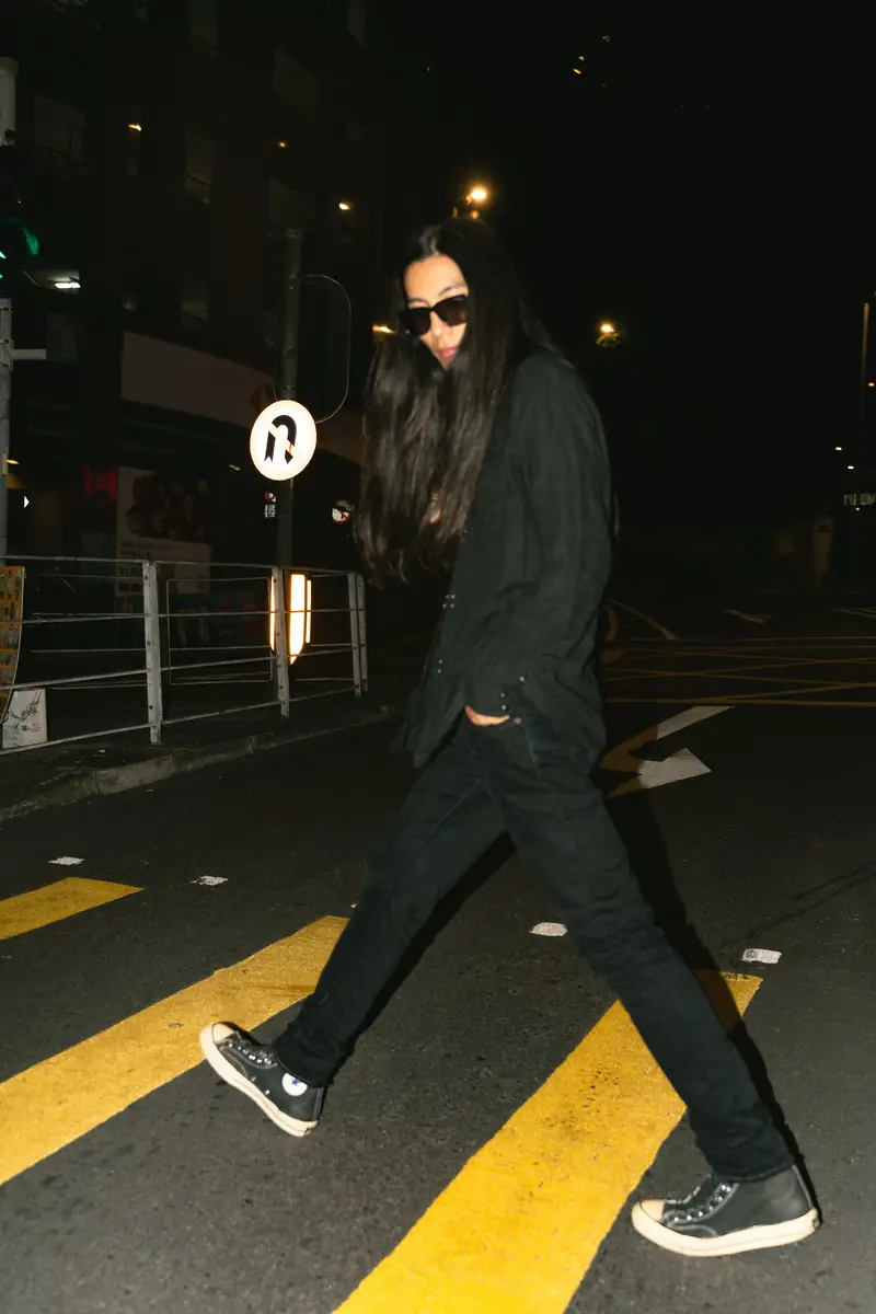 Model walking across a road at night