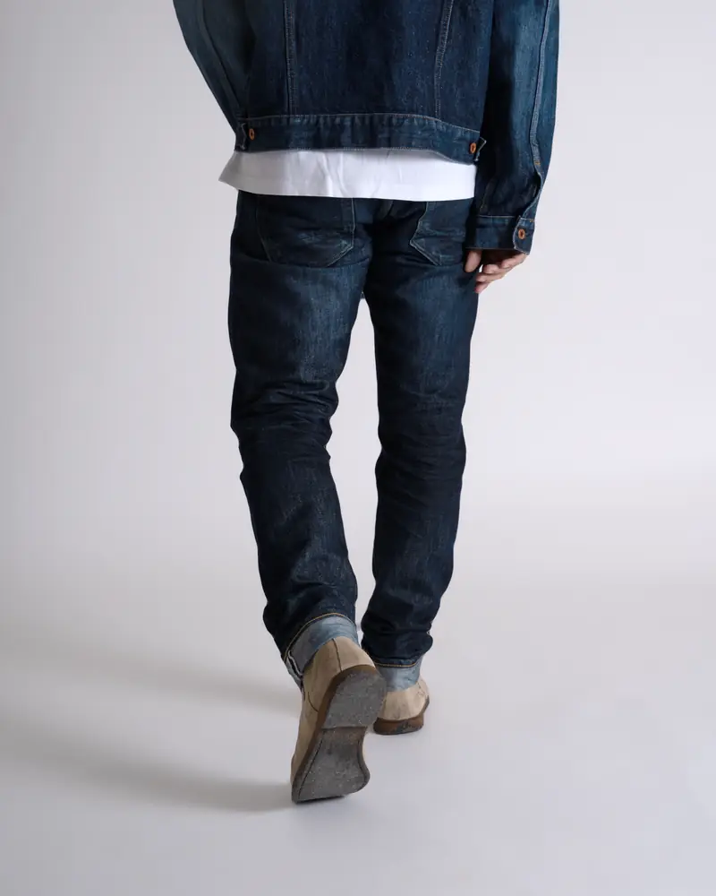 Close-up of jeans and boots mid-stride